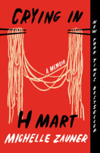 Crying in H Mart book cover, red with Asian noodles held by chopsticks